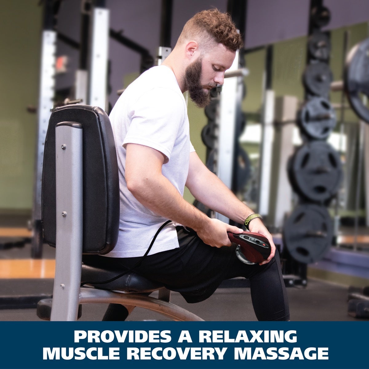 Active user seated on training bench applying the Wahl Deluxe Heat Massager to the leg for muscle recovery